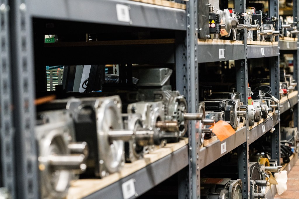 A well-organized industrial stockroom showcasing multiple shelves filled with various motors and equipment components.